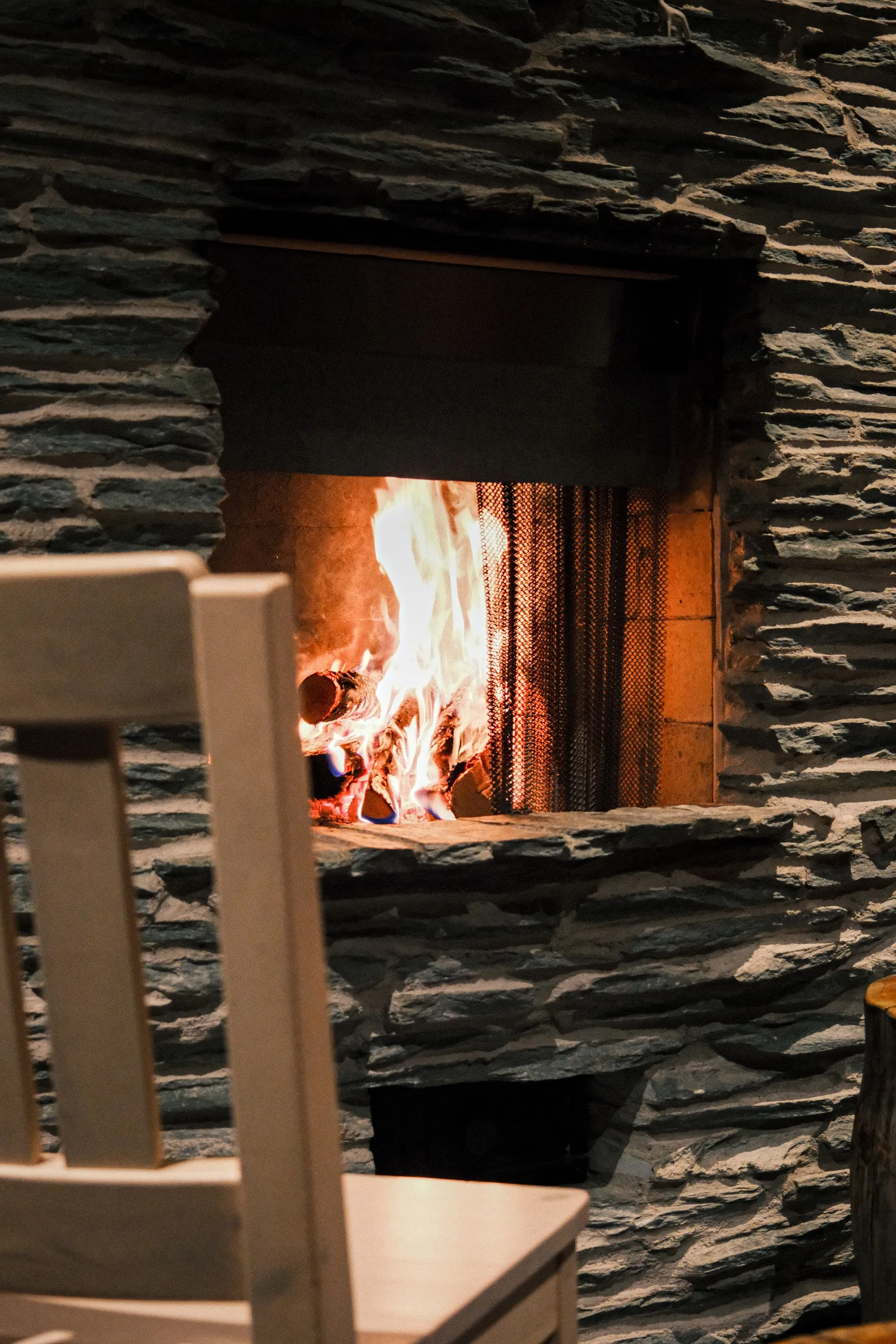 Stone fireplace with a wood fire burning
